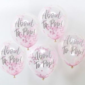 GingerRay_about_to_pop_pink_confetti_balloons-min